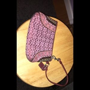 a purple coach wristlet